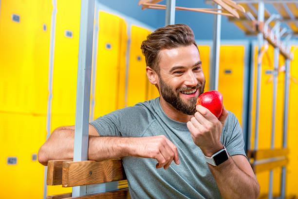 Man with apple in the gym