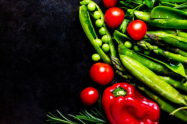 istock Food background. Fresh vegetables on black. Top view 627250824