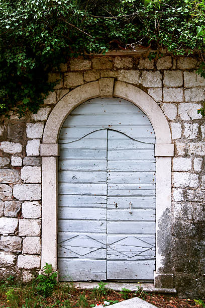 istock Old door and window on a stone wall 627253878