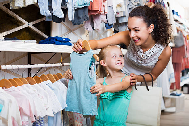 istock Mother with daughter buying clothes 627262694