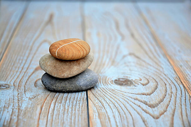 istock Three zen stones old wooden background with empty copy space 627262880