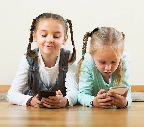 istock Girls playing online with phones 627264280