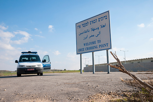 Erez Crossing, Israel - November 18, 2006: An Israeli police vehicle is parked next to a sign that reads \