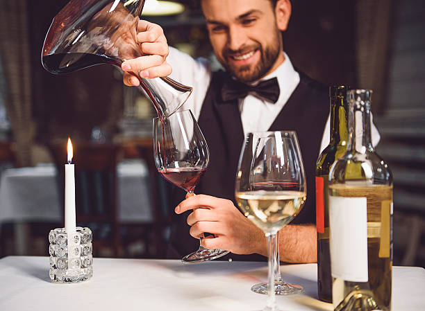 istock Man pouring scarlet wine in glass 627269214