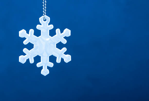 Cute white safety reflector in the form of snowflakes on stock photo