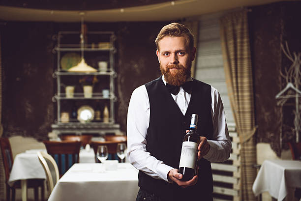 istock Man presenting bottle of wine 627269736