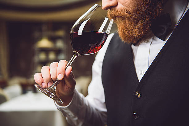 Only truly connoisseur can feel fragrance Close up. Bearded serious man is inhaling aroma of scarlet wine with pleasure sommelier photos stock pictures, royalty-free photos & images