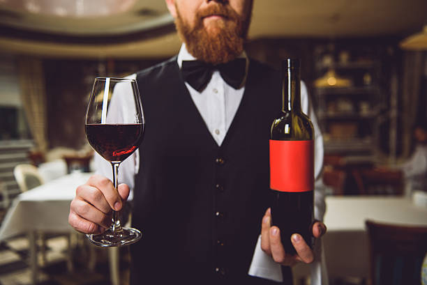 istock Man showing bottle and glass of red wine 627270068