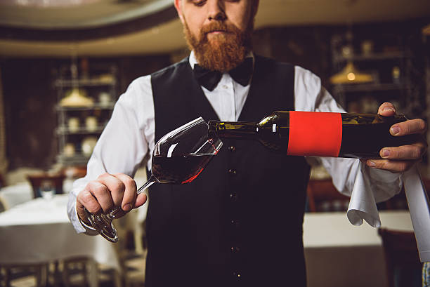 istock Process of pouring wine into polished glass 627270120