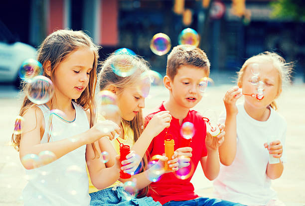 istock Children make soap bubles outdoors 627270154