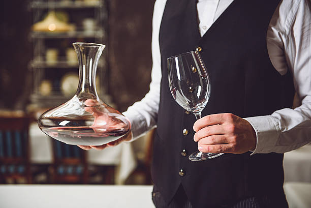 istock Man taking vase with wine and goblet 627270410