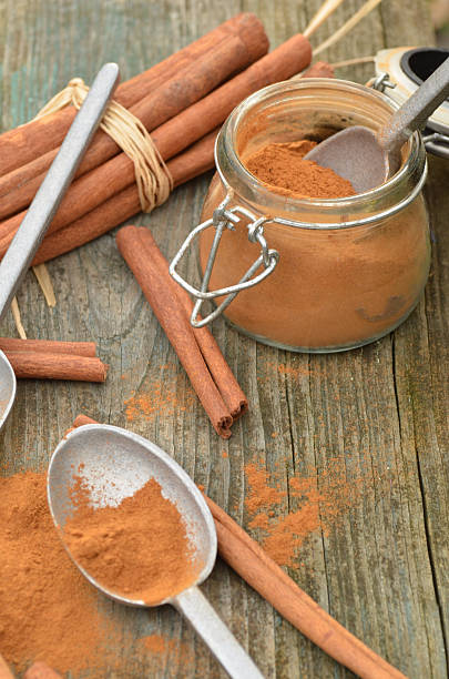 istock cinnamon powder in spice jar, spoons, cinnamon sticks 627270698