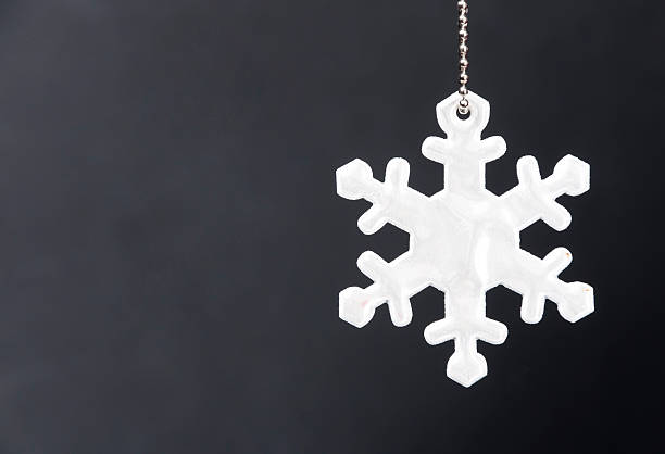Cute white safety reflector in the form of snowflakes on stock photo