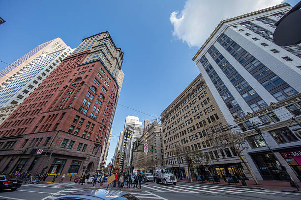 San Francisco, CA, USA - November 23, 2016:   San Francisco downtown street view. Residential and business buildings on the roadside. Incidental people on the background.