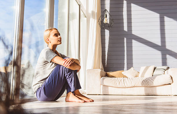 istock Dreamful young woman relaxing at home 627279792