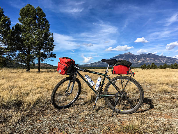Mountain Bike in a Meadow This mountain bike was photographed in a meadow on Observatory Mesa. The San Francisco Peaks are in the background. Observatory Mesa is in the Coconino National Forest near Flagstaff, Arizona, USA. jeff goulden mountain stock pictures, royalty-free photos & images