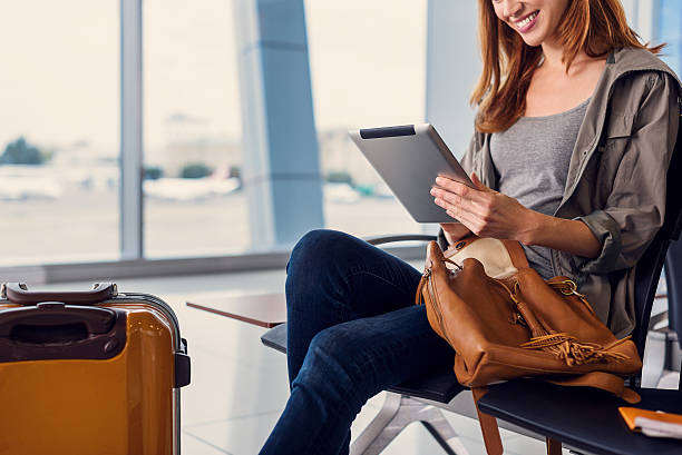 istock Beautiful girl using tablet in airport 627281402