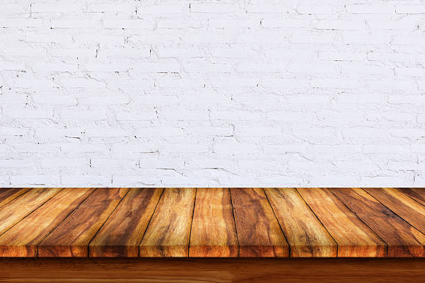 istock Empty top of wooden table with white brick background. 627281530