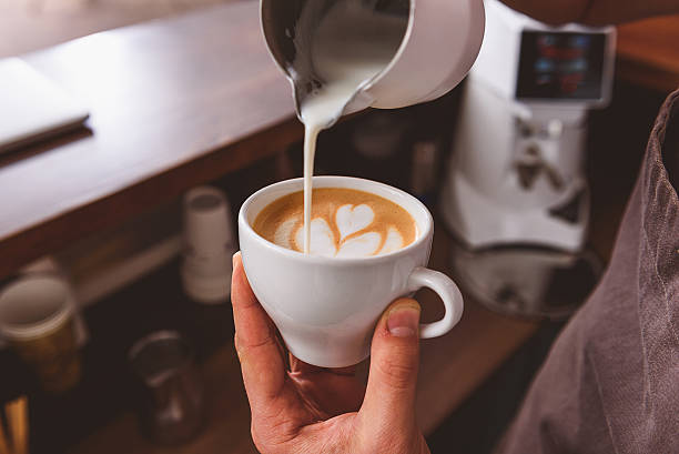 istock man showing how to make coffee art 627284644