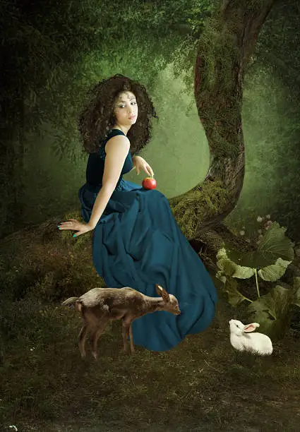 Girl with long hair with an apple sitting on a tree in a forest, surrounded by fawn and hare.