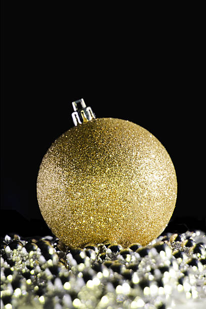 istock Gold shimmering christmas ball on black background 627289866