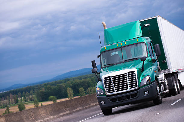 istock Green semi truck with container trailer on highway 627290218