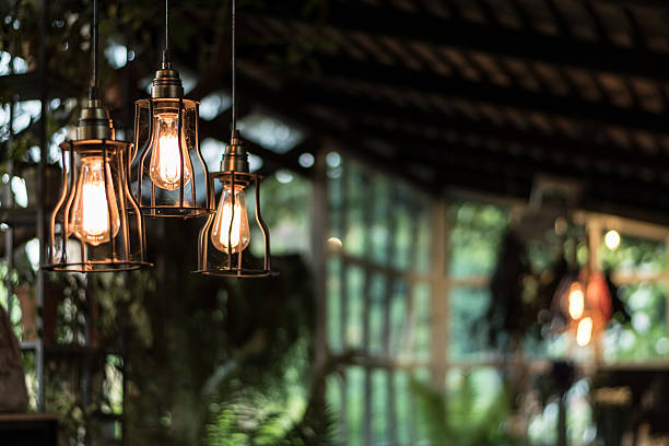 istock beautiful Light bulb incandescent hanging decorated interior roo 627290940