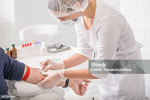 Skillful General Practitioner Testing Male Blood Stock Photo - Download Image Now - Blood, Blood Donation, Medical Test
