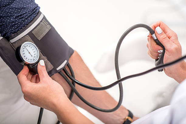 istock Physician checking male pulse by equipment 627297430