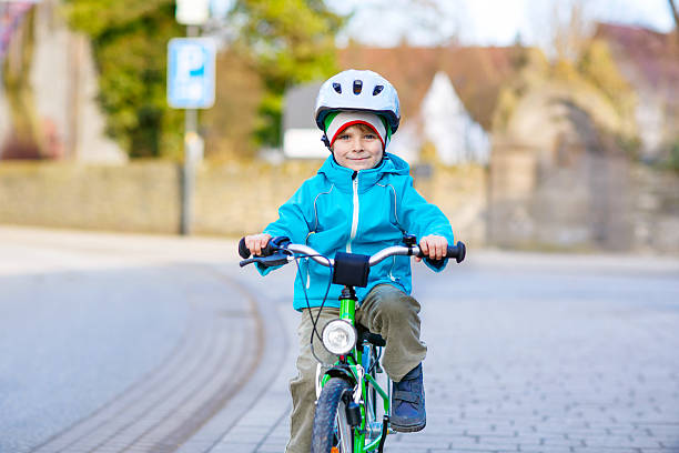 istock Little preschool kid boy riding on bicycle 627304908