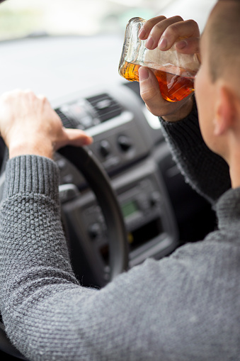 Man drinking alcohol and driving