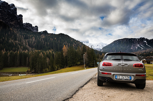 Lago di Braies, BZ, Italy - November 23, 2016: Mini Cooper D Clubman parked on a side of the road close to the Braies Lake in Italy on the Italian side of the Alps. On the background are visible the snowy Dolomites peaks. The car is shot from a rear point of view