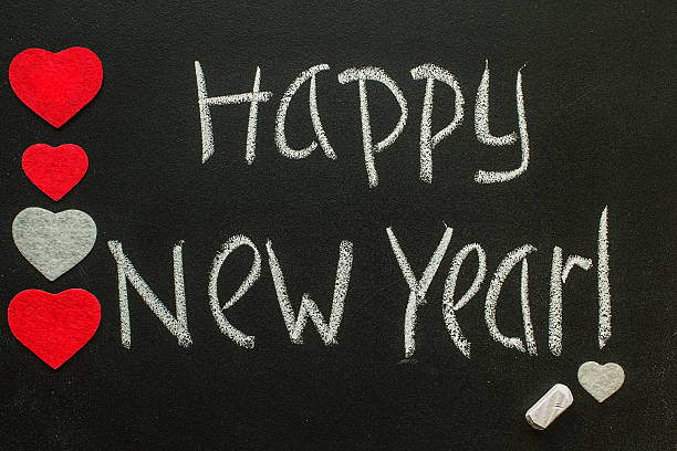 istock Happy New Year written on blackboard with hearts 627306824