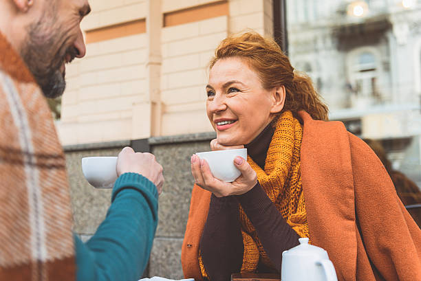 istock Happy man and woman drinking hot beverage 627306998