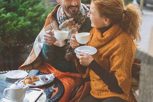 istock Happy loving couple enjoying breakfast in cafe 627313600