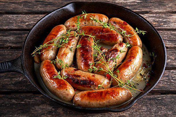 istock Home-made Pork Sausages in rustic pan with thyme 627317664