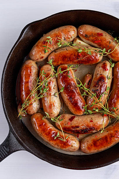 istock Home-made Pork Sausages in rustic pan with thyme 627317778