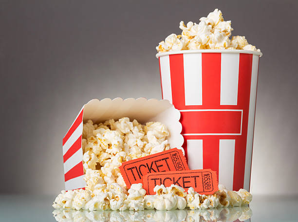 istock Movie tickets spilled popcorn and two boxes on a gray 627319264