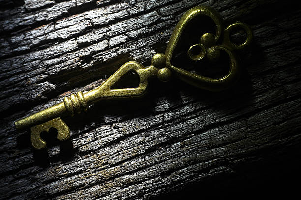 istock Golden key on rusty wooden table 627319872