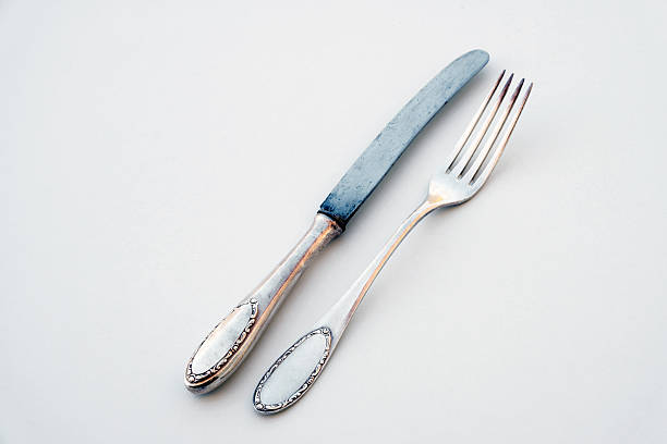 istock knife and fork isolated on white - beautiful silver cutlery 627320864