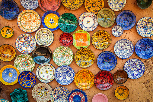 Beautiful arabic colorful hand made pottery bowls on display in the market in Morocco