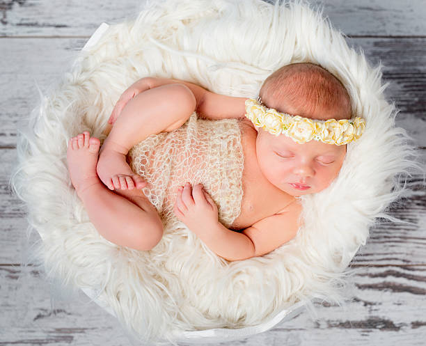 istock sleeping newborn girl on round bed in funy pose 627329710