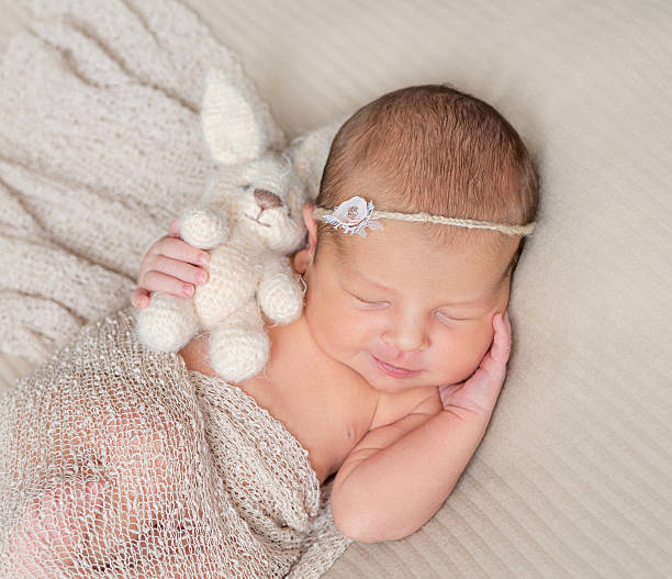 istock sweet sleeping infant with toy in hand 627330290