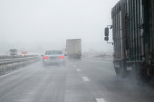 cars, trucks and rescue vehicle driving in dangerous winter weather