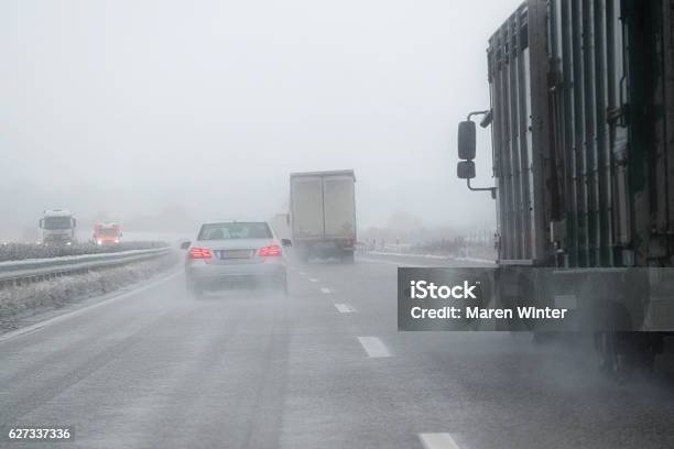 Cars Trucks And Rescue Vehicle Driving In Dangerous Winter Weather Stock Photo - Download Image Now