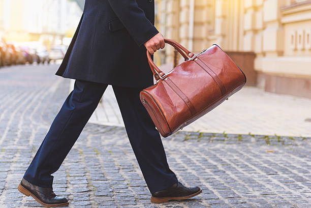 istock Busy man walking on street with briefcase 627337530