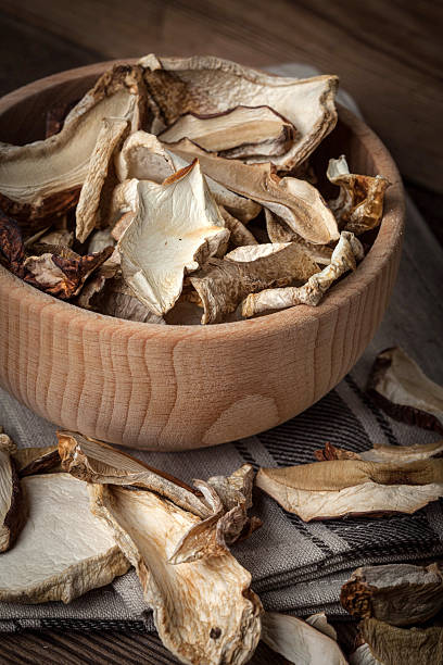 istock Dried mushrooms in wooden bowl. 627338086
