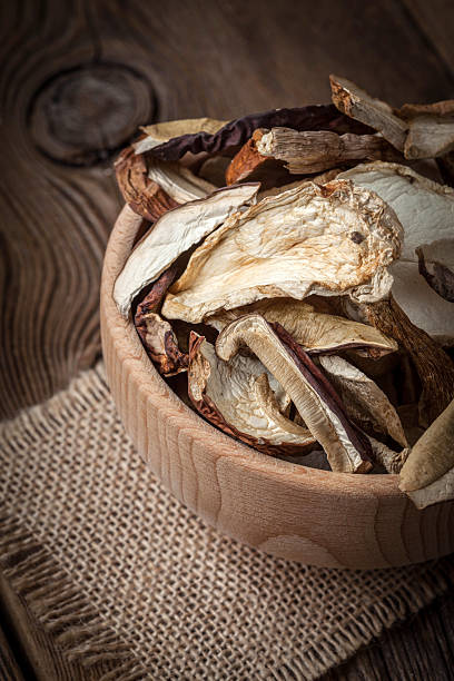 istock Dried mushrooms in wooden bowl. 627338178