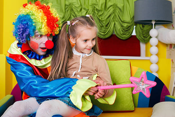 istock Girl playing with cheerful clown 627340234