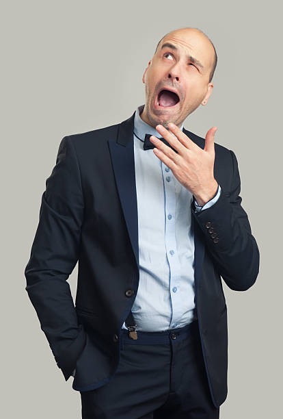 istock bored bald stylish man yawning and looking up 627340760